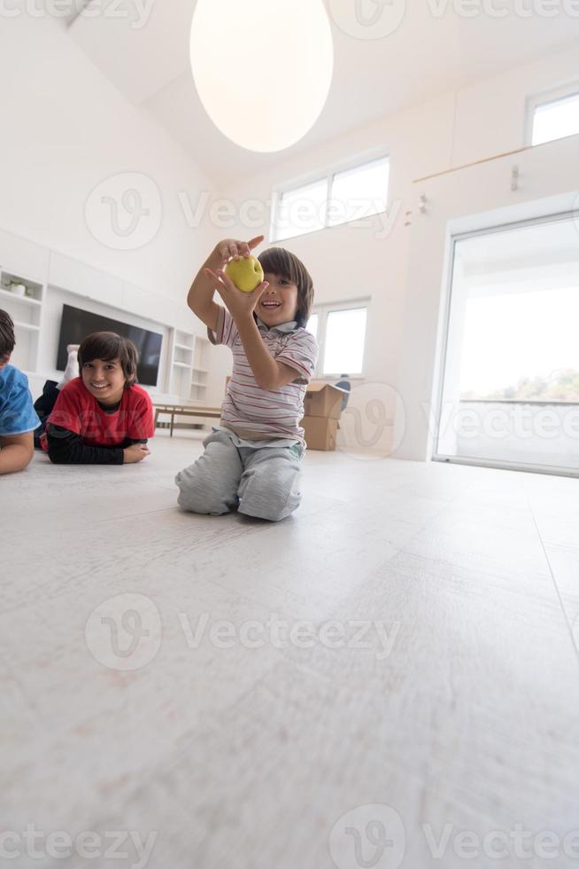 boys having fun with an apple on the floor photo