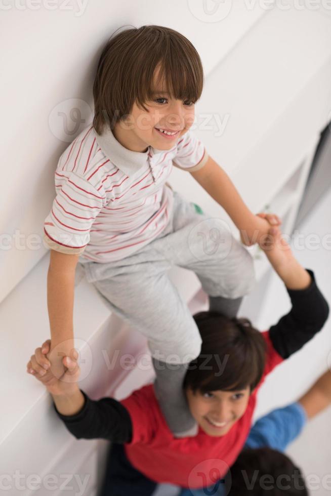 young boys posing line up piggyback top view photo