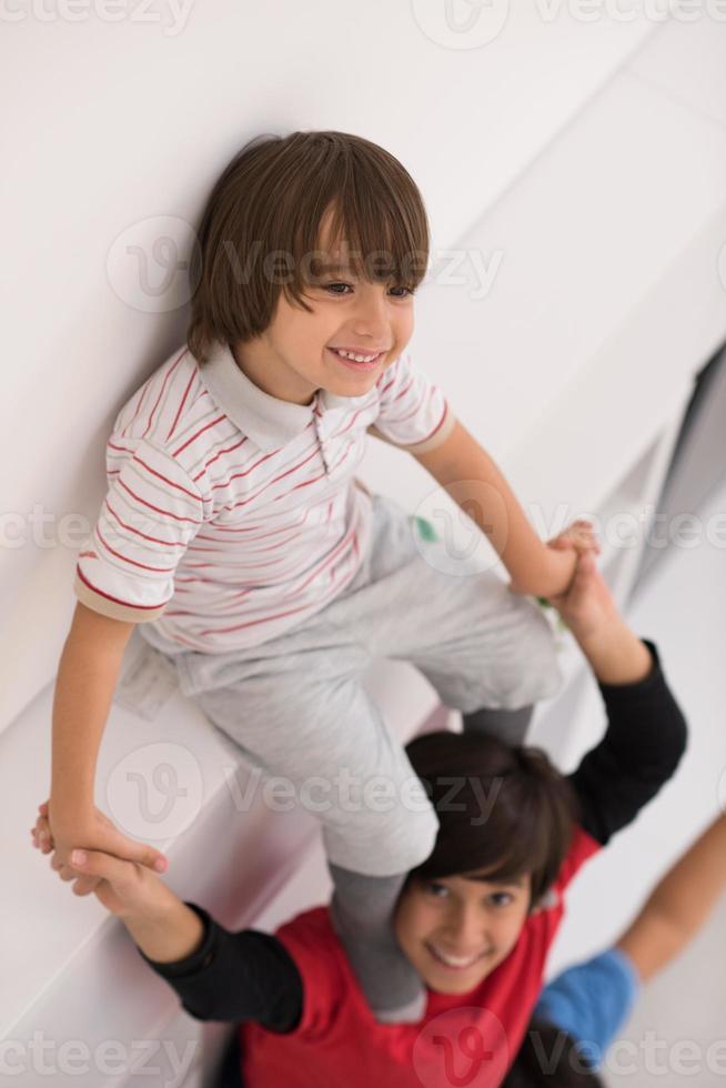 young boys posing line up piggyback top view photo