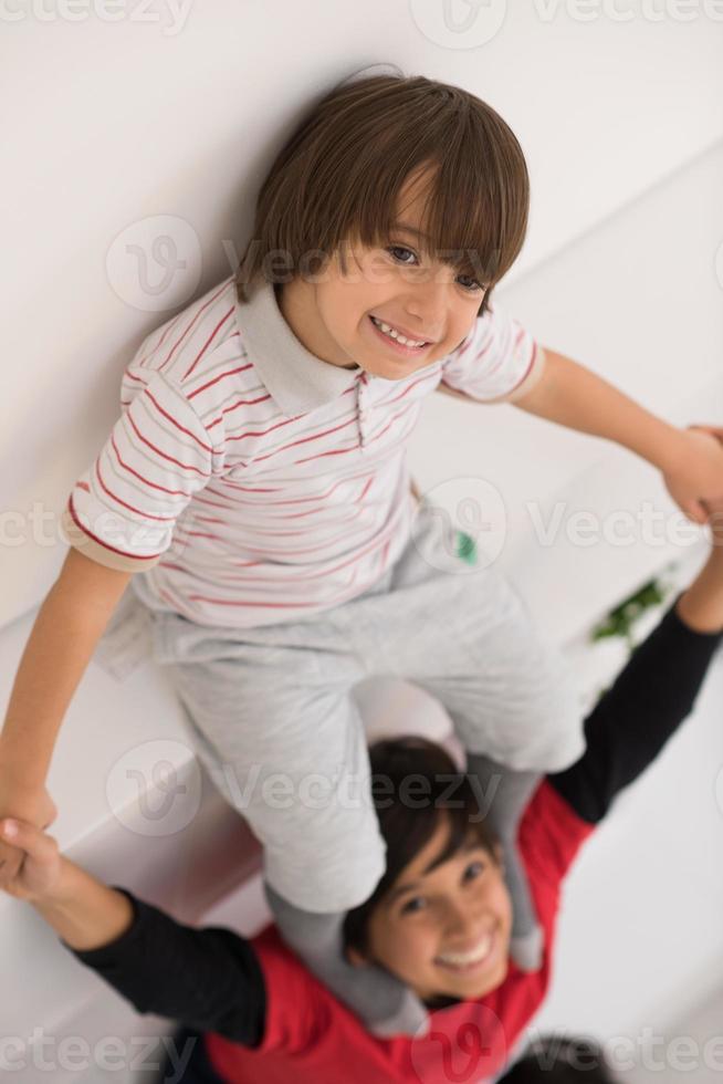 young boys posing line up piggyback top view photo