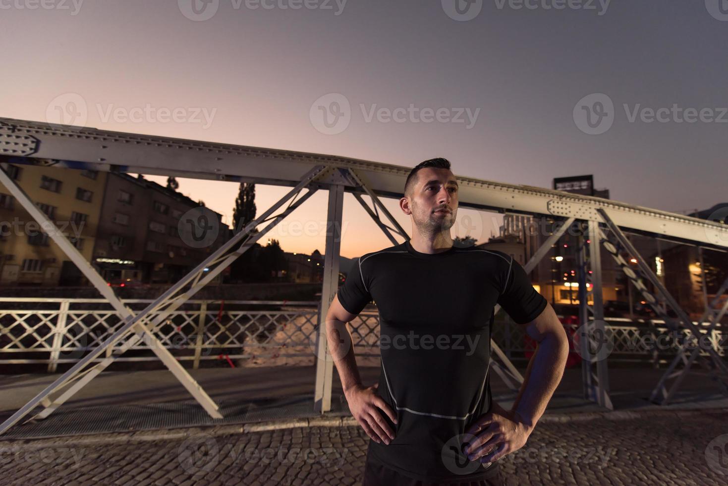 man jogging across the bridge in the city photo