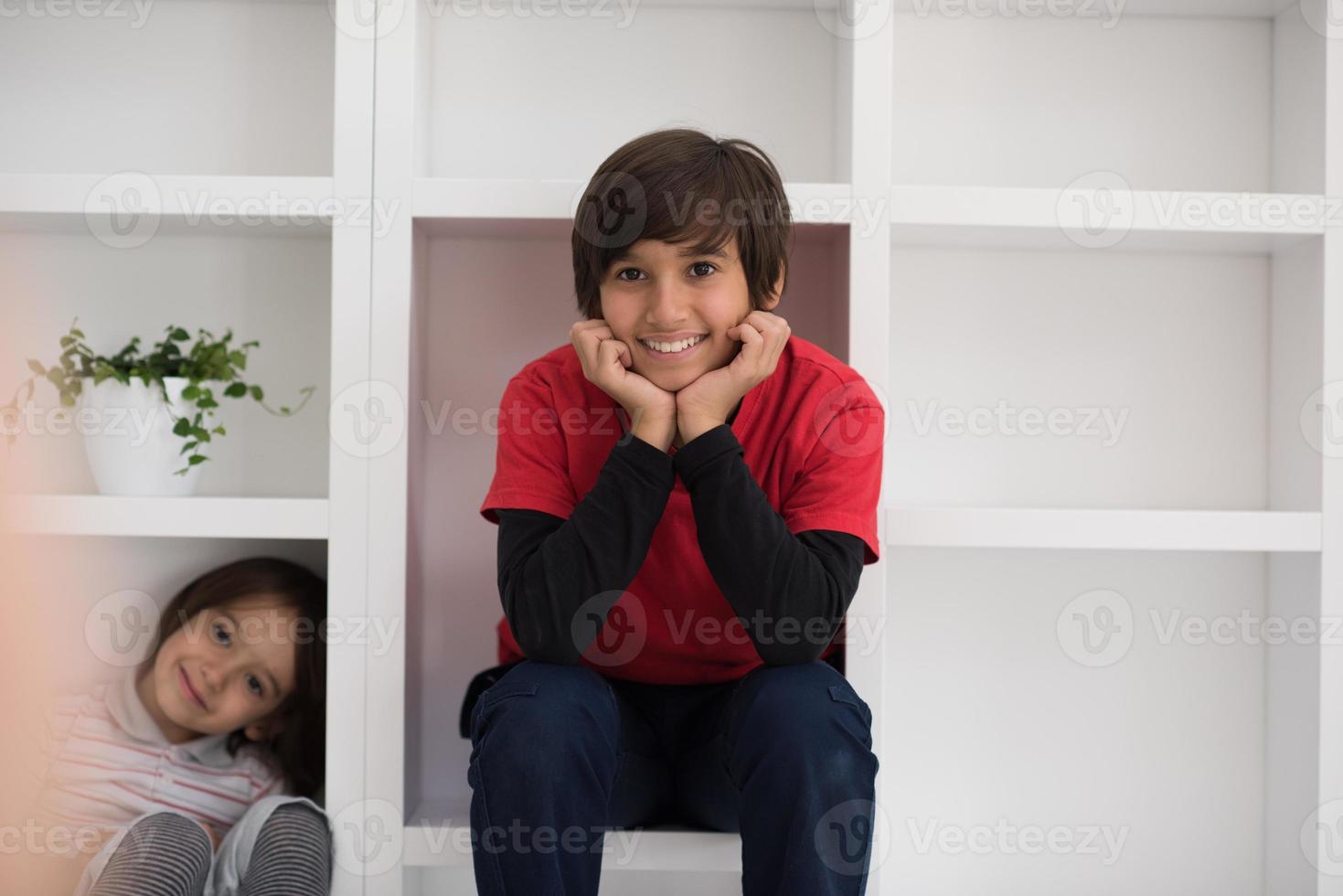 young boys posing on a shelf photo