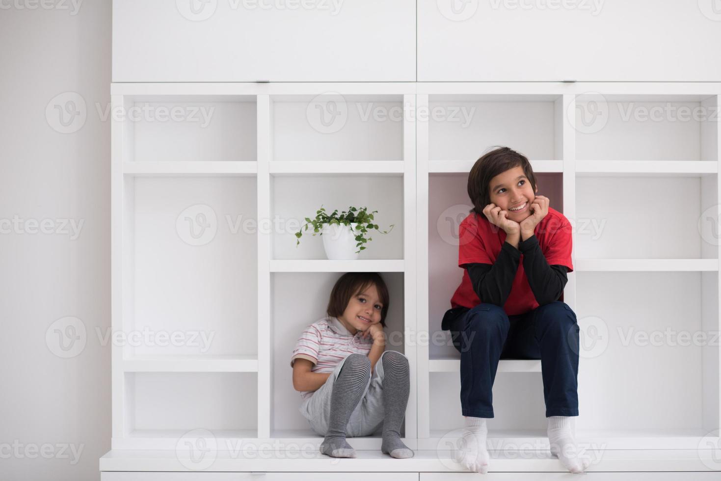 young boys posing on a shelf photo