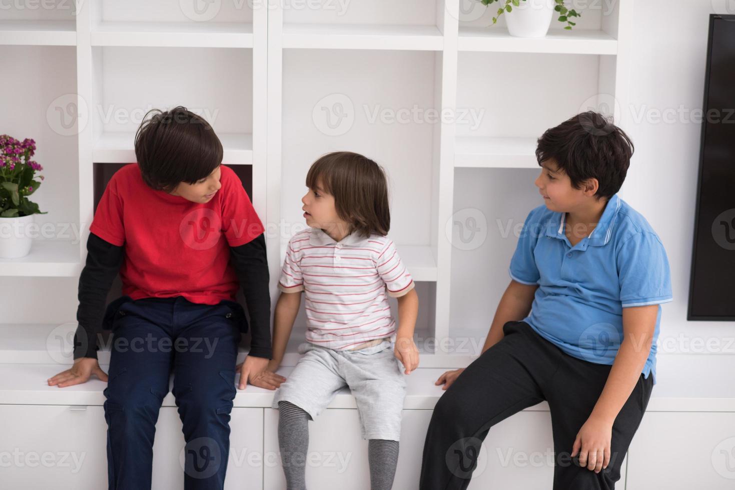 young boys posing on a shelf photo