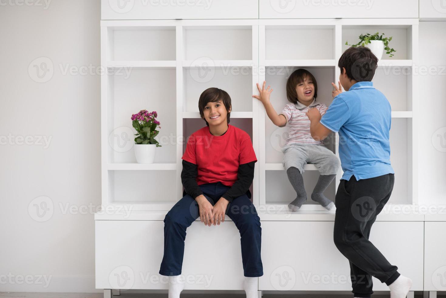 young boys posing on a shelf photo