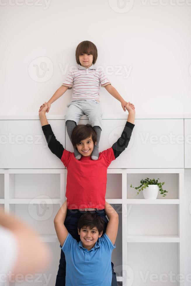 young boys posing line up piggyback photo