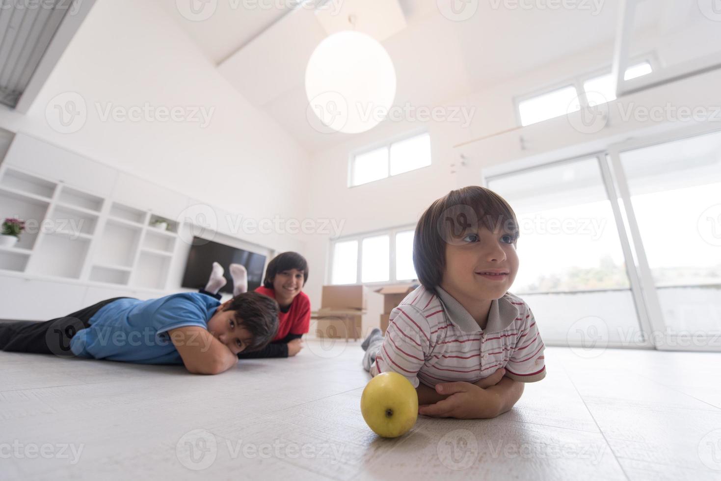 boys having fun with an apple on the floor photo