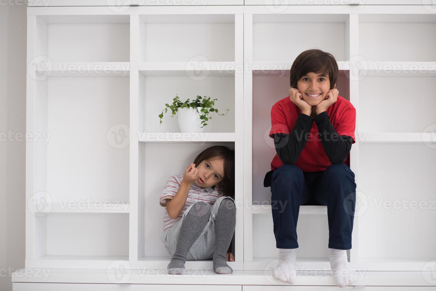 young boys posing on a shelf photo