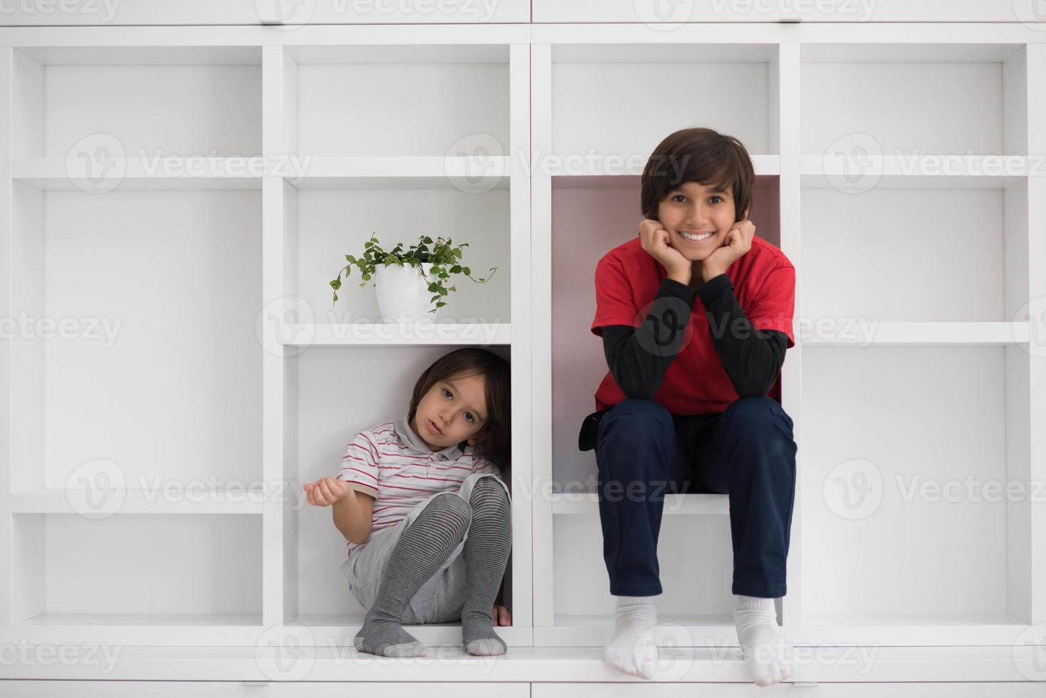 young boys posing on a shelf photo