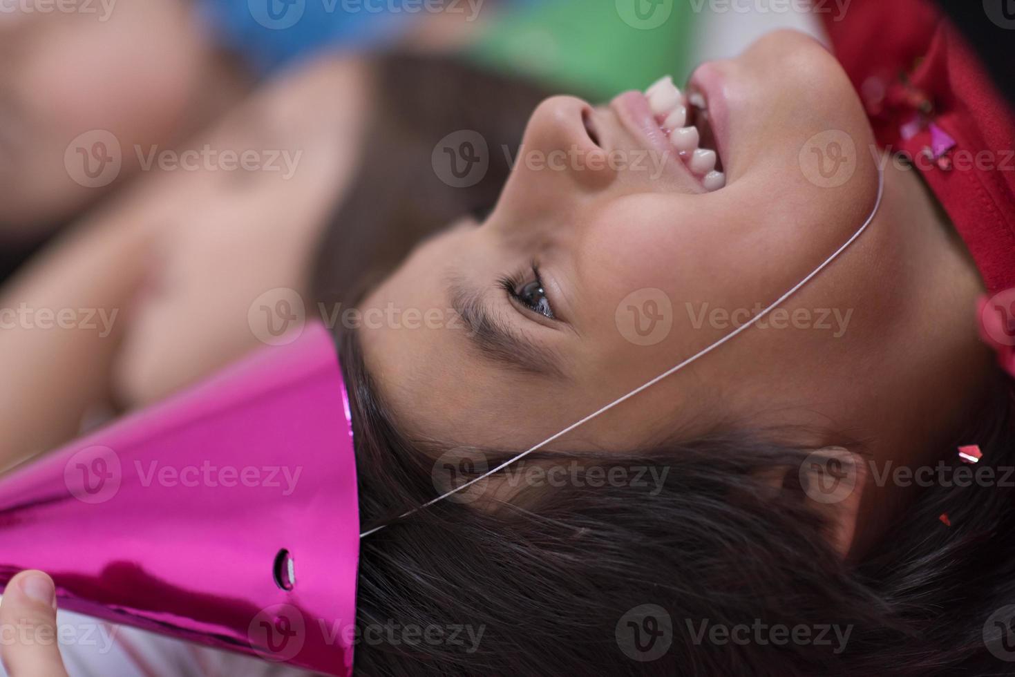 kids  blowing confetti while lying on the floor photo