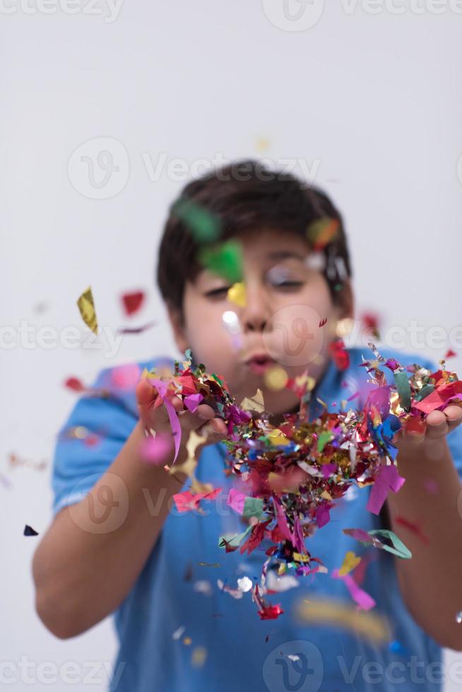 kid blowing confetti photo
