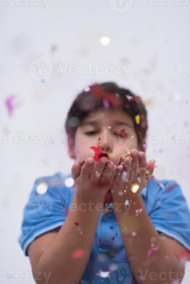 kid blowing confetti photo