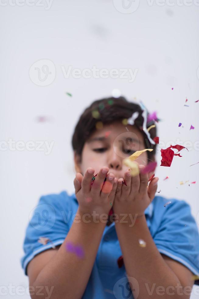 kid blowing confetti photo