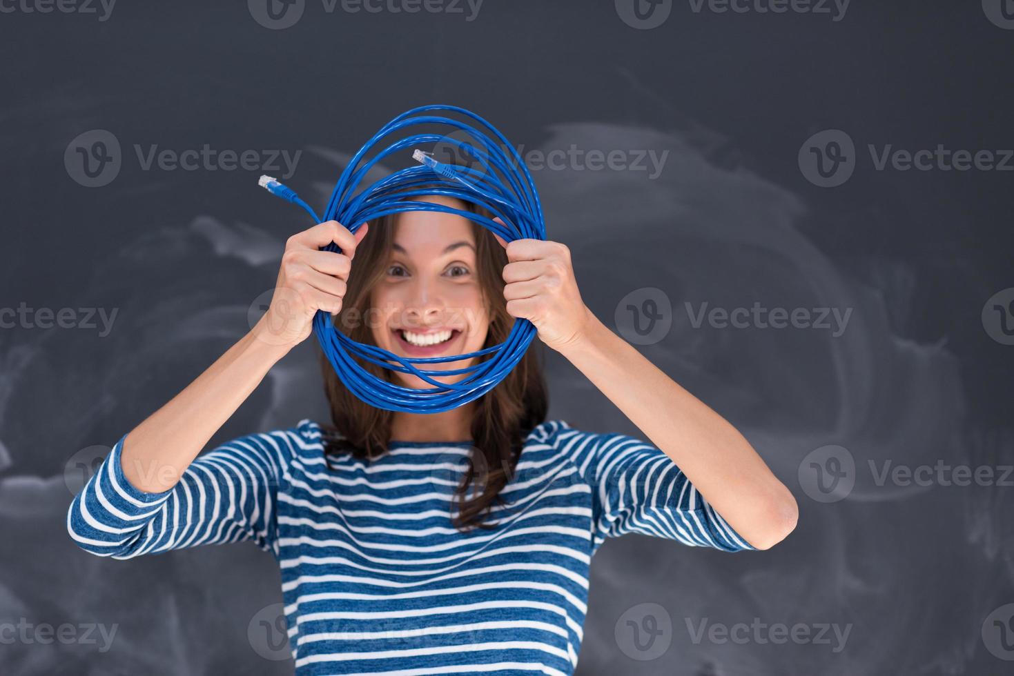 woman holding a internet cable in front of chalk drawing board photo