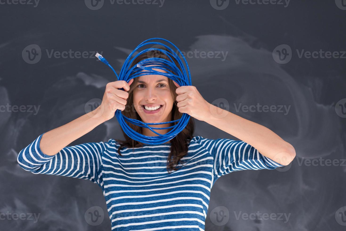 woman holding a internet cable in front of chalk drawing board photo