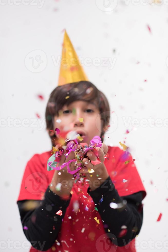 kid blowing confetti photo