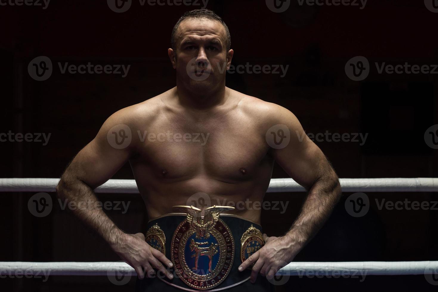 kick boxer with his championship belt photo