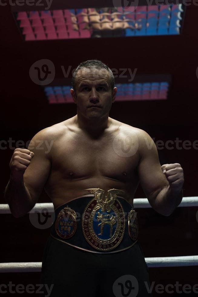 kick boxer with his championship belt photo