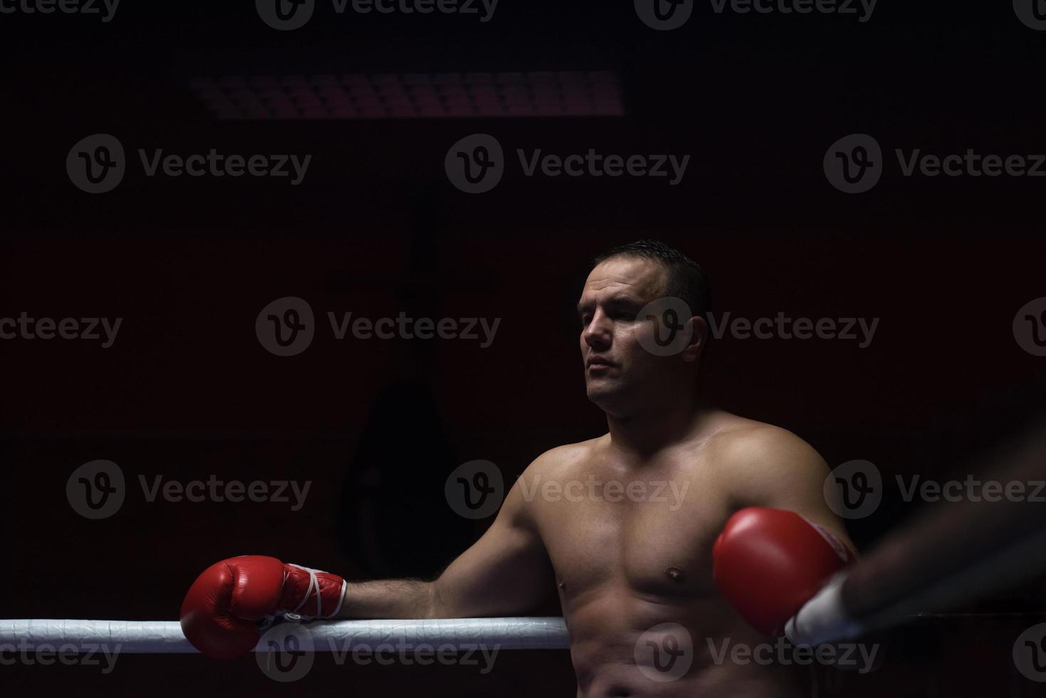 kick boxer descansando sobre las cuerdas en la esquina foto