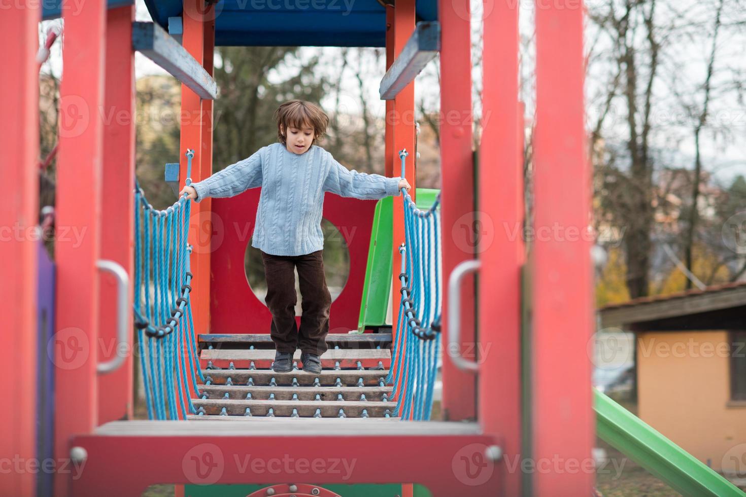 cute little boy having fun in playground photo