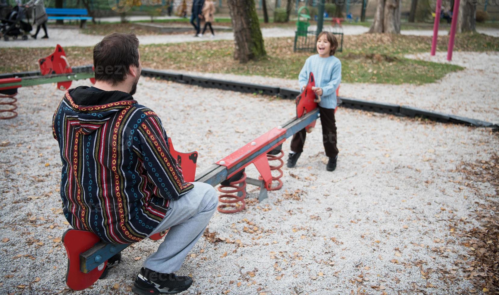 father and  child having fun together  in park photo