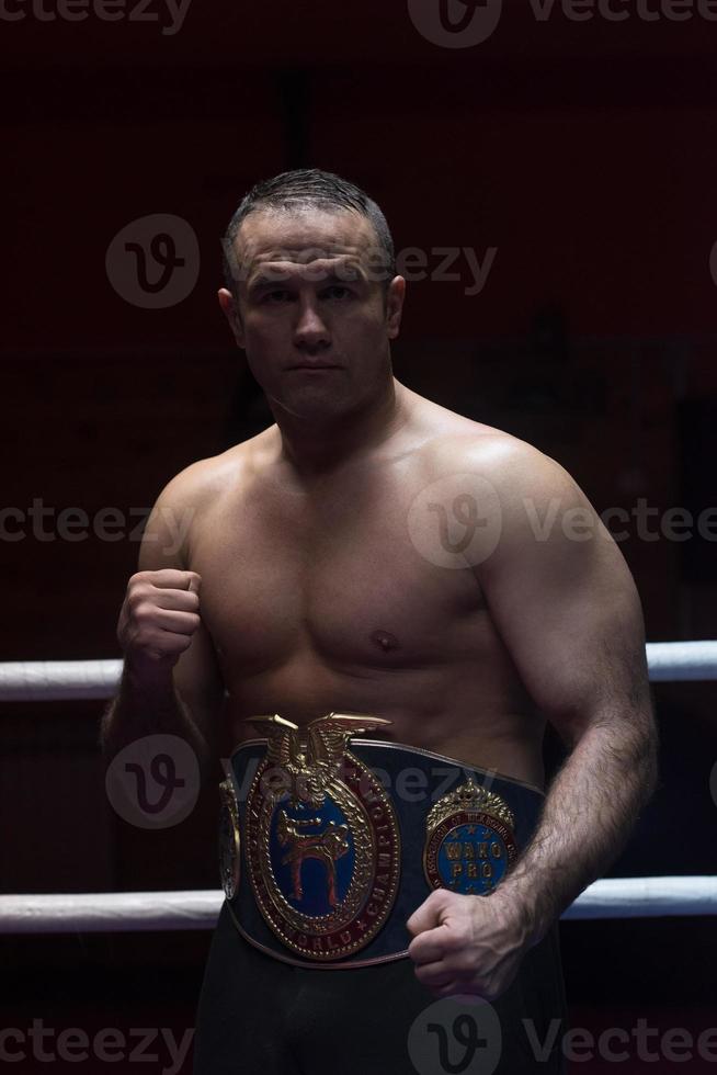 kick boxer with his championship belt photo