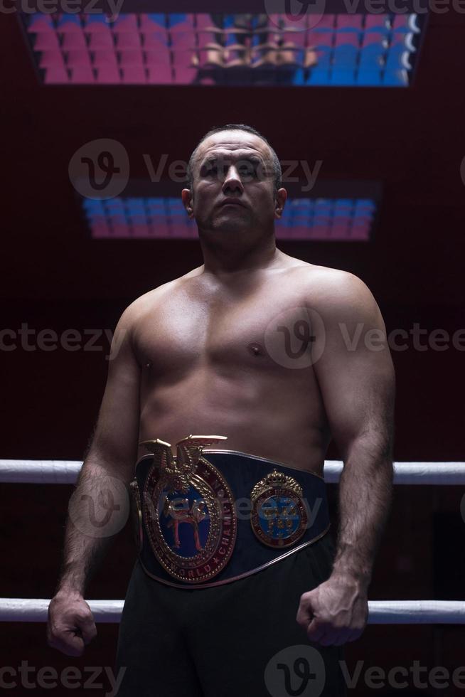 kick boxer with his championship belt photo