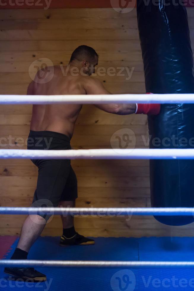 kick boxer training on a punching bag photo