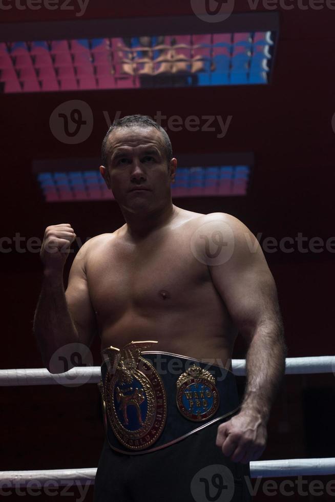 kick boxer with his championship belt photo