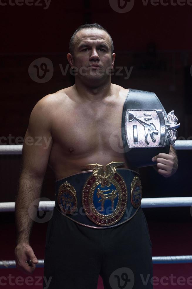 kick boxer with his championship belt photo