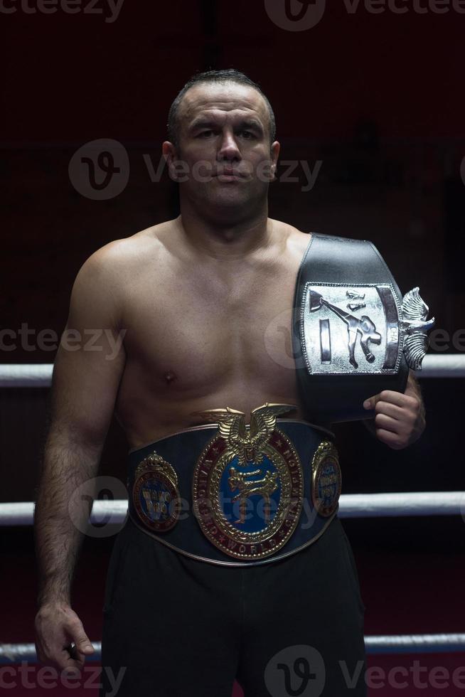 kick boxer with his championship belt photo