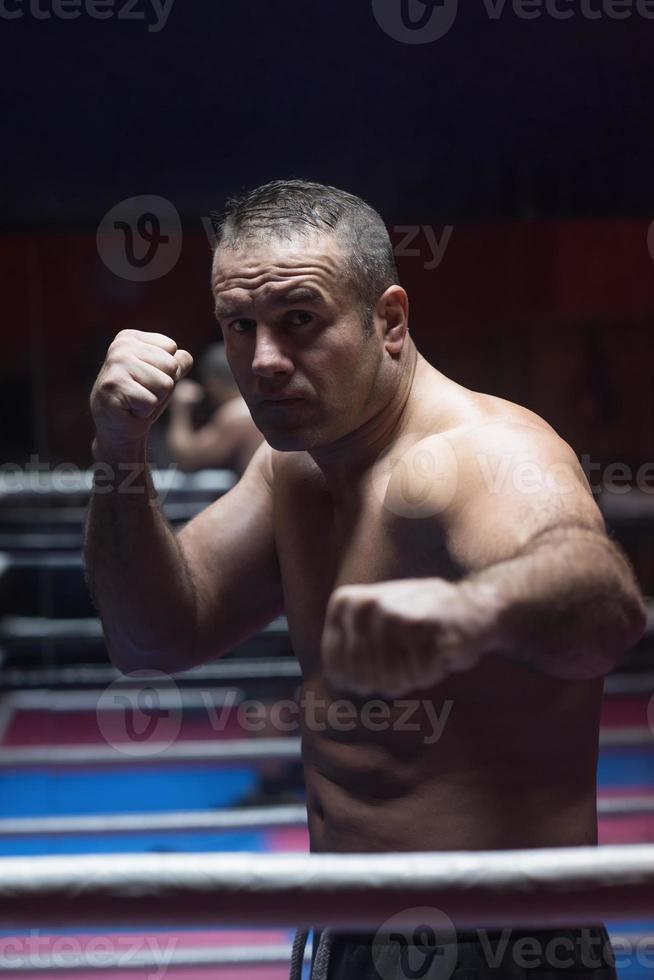 professional kickboxer in the training ring photo