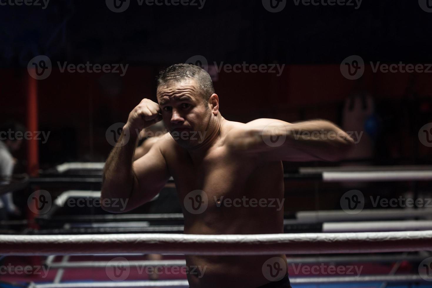 professional kickboxer in the training ring photo