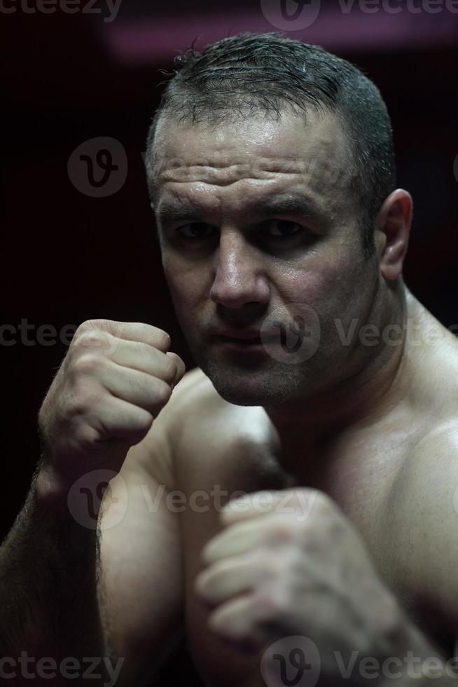 professional kickboxer in the training ring photo