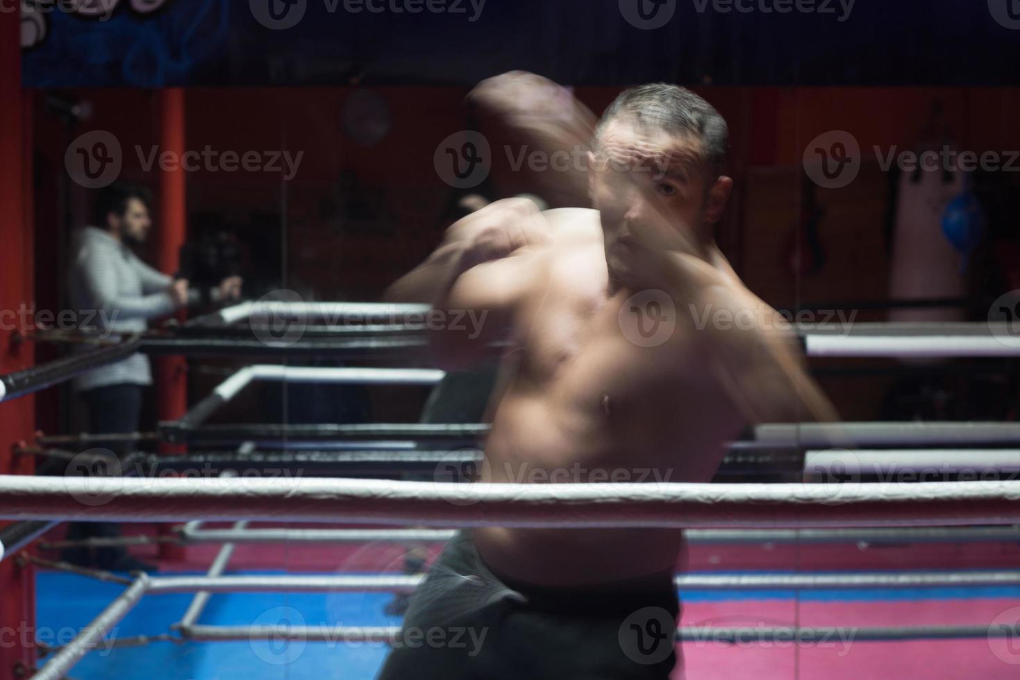 professional kickboxer in the training ring photo