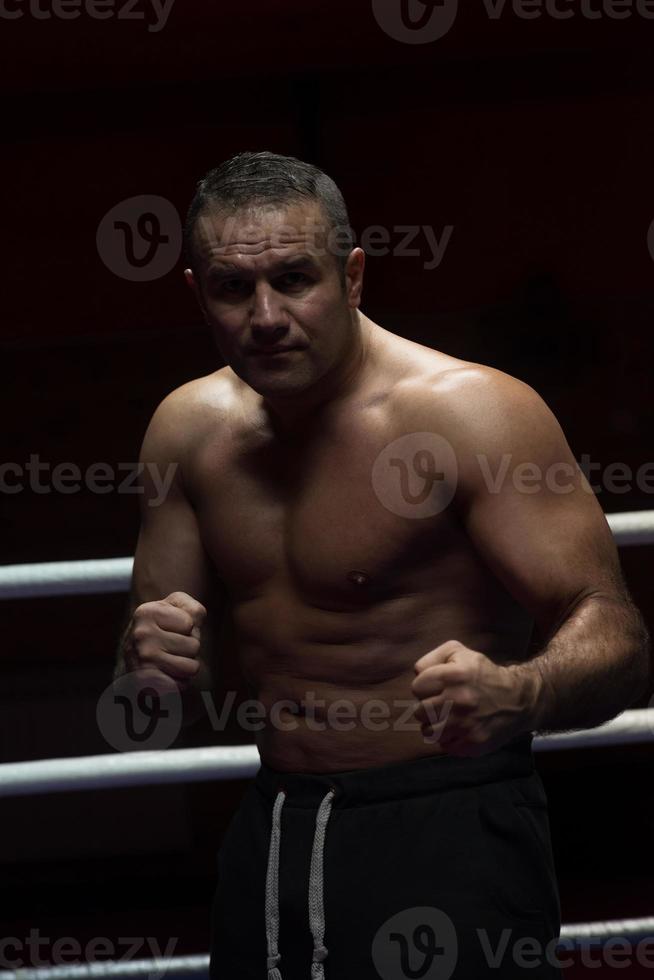 professional kickboxer in the training ring photo