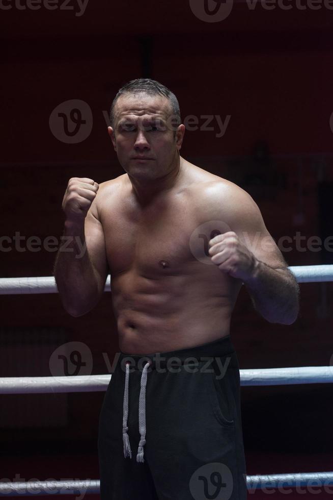 professional kickboxer in the training ring photo