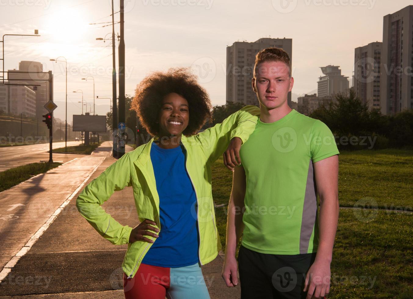 Portrait of romantic pretty couple on fitness session, outside town background photo