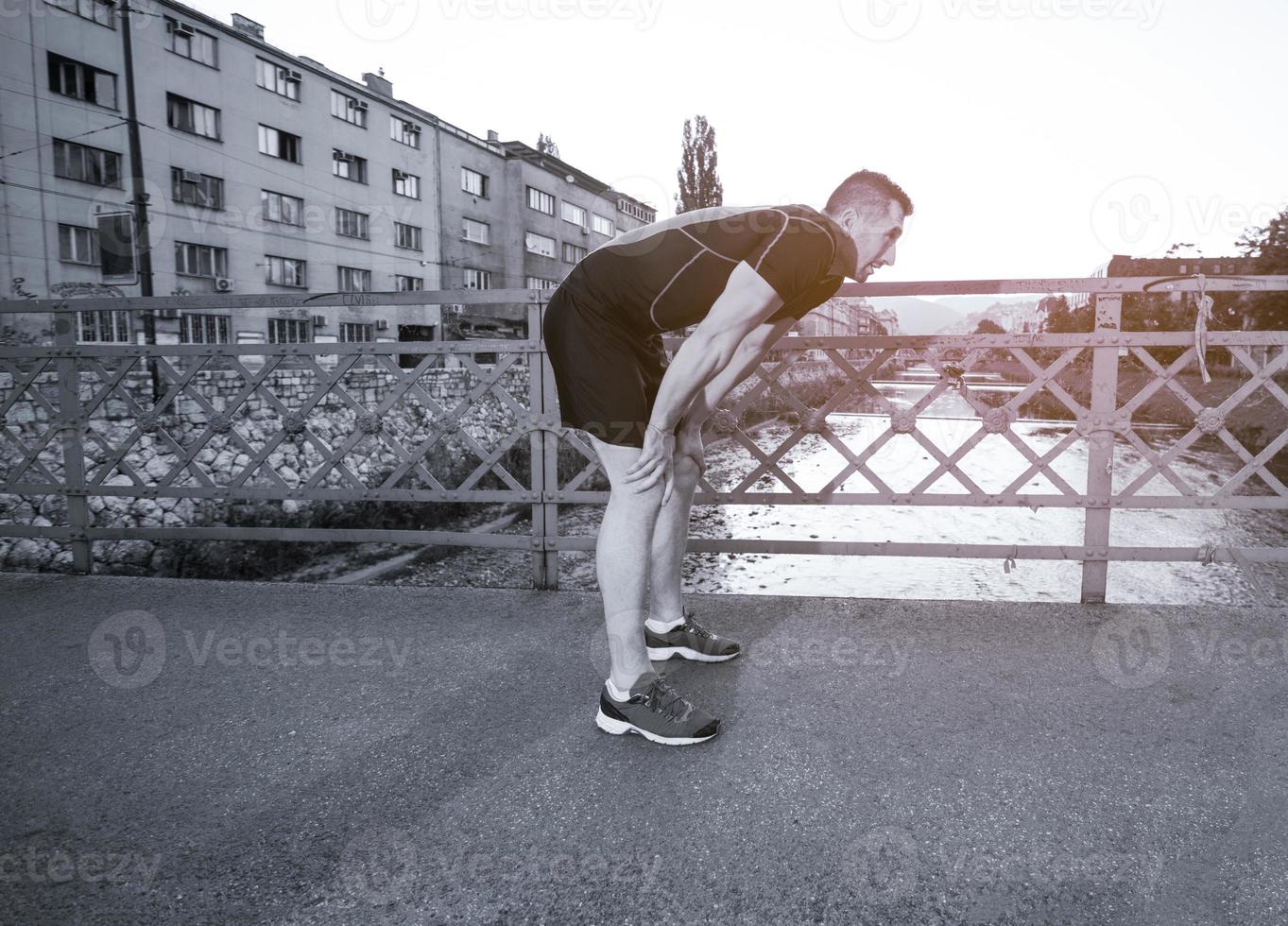 man jogging across the bridge at sunny morning photo