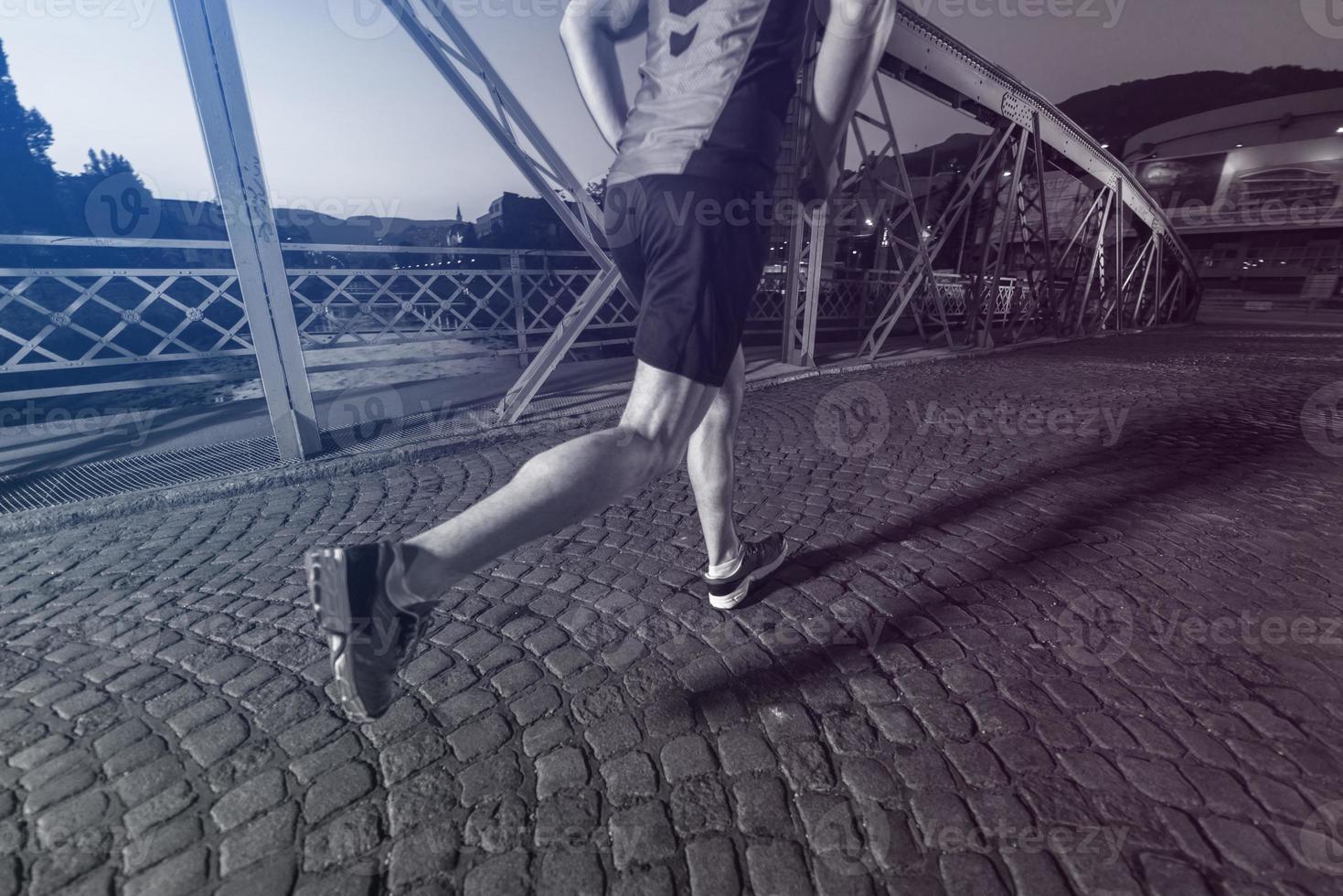 man jogging across the bridge in the city photo