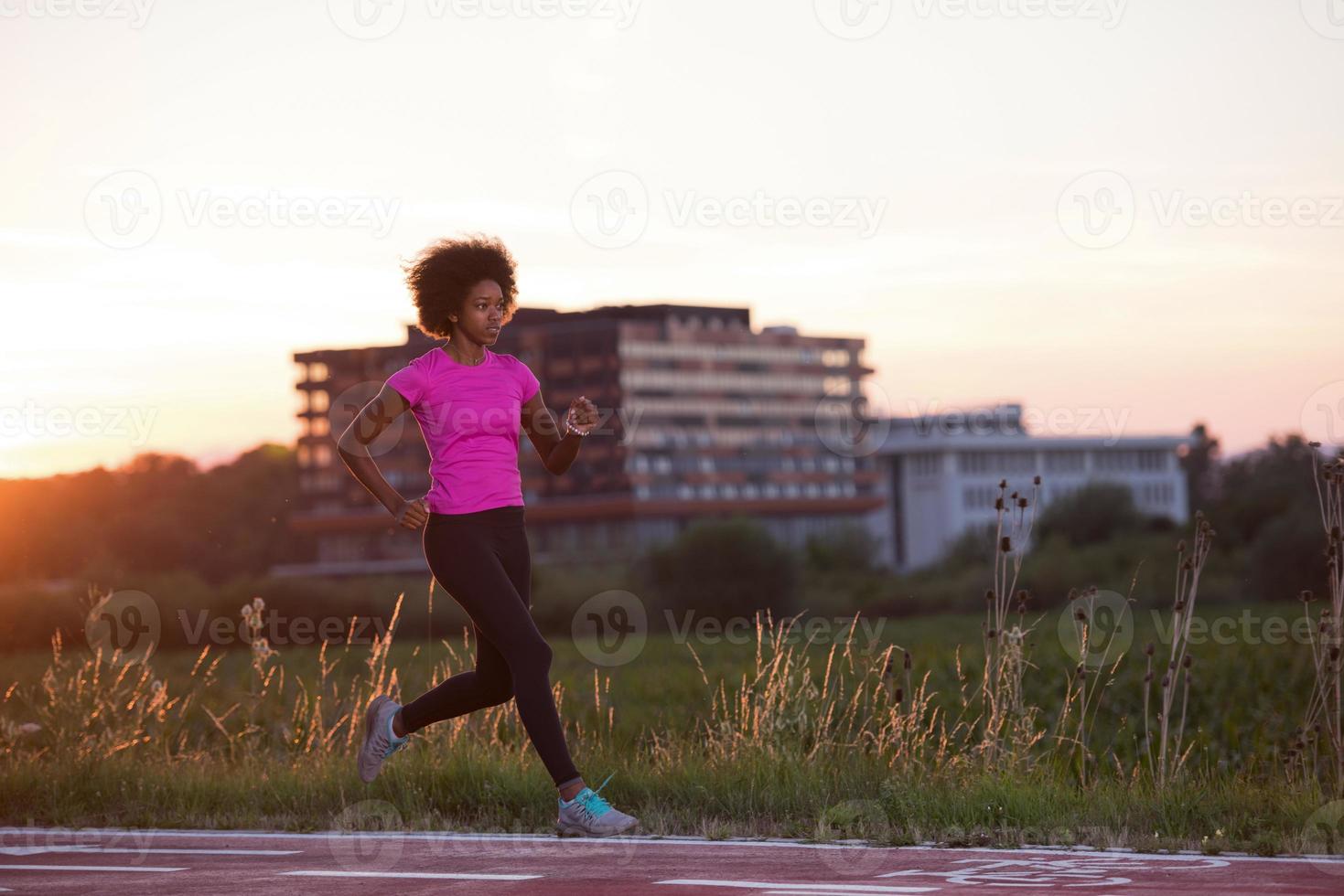 a young African American woman jogging outdoors photo