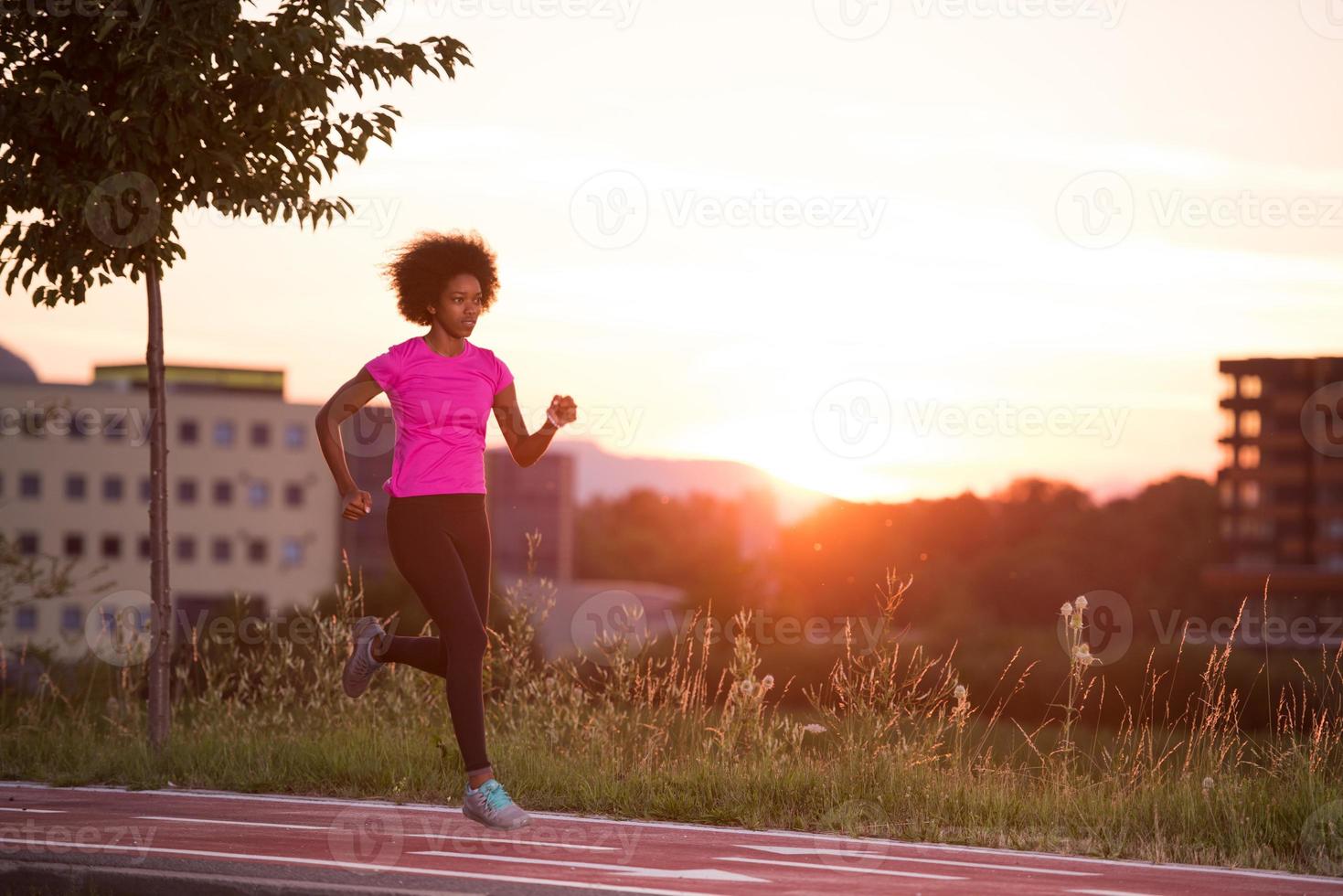 a young African American woman jogging outdoors photo