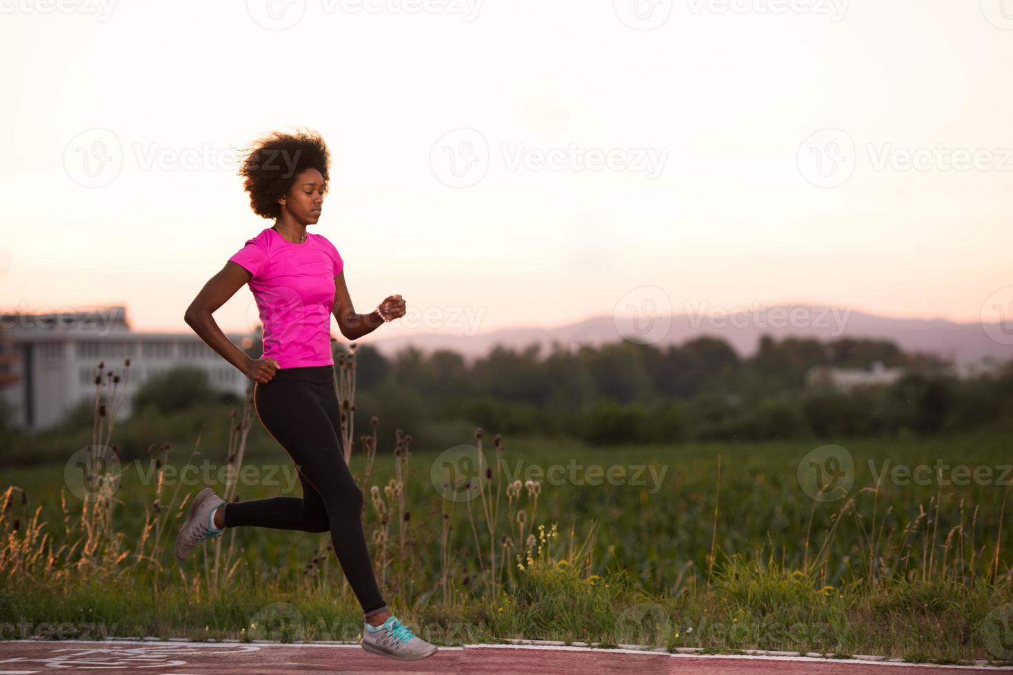 a young African American woman jogging outdoors photo
