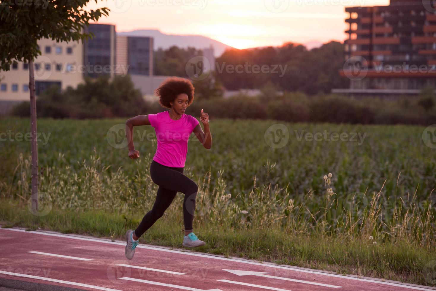 a young African American woman jogging outdoors photo