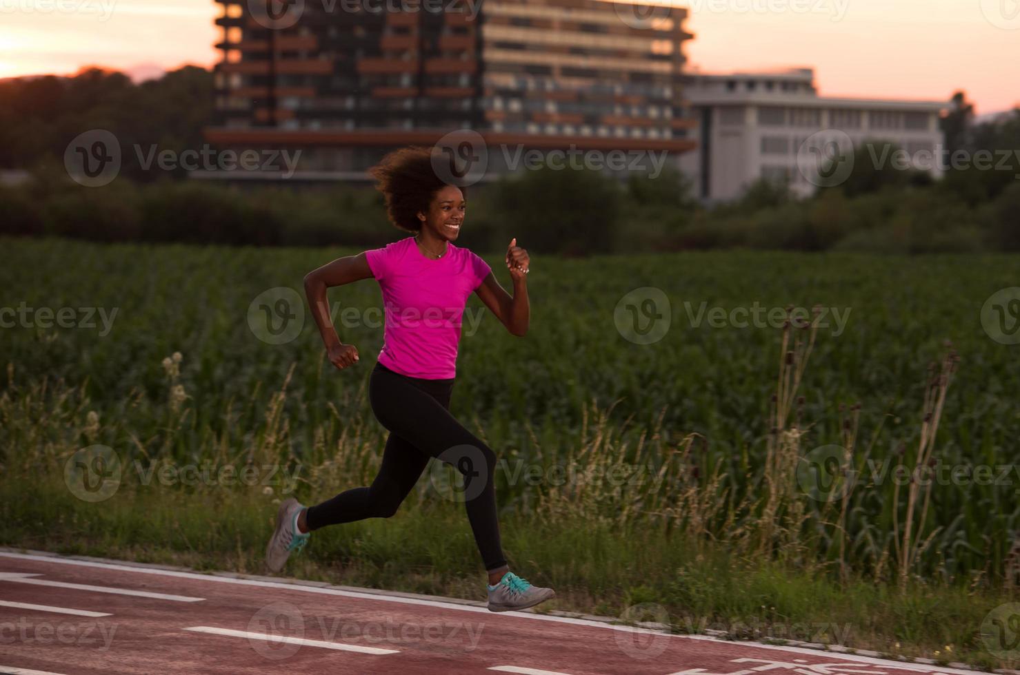 a young African American woman jogging outdoors photo