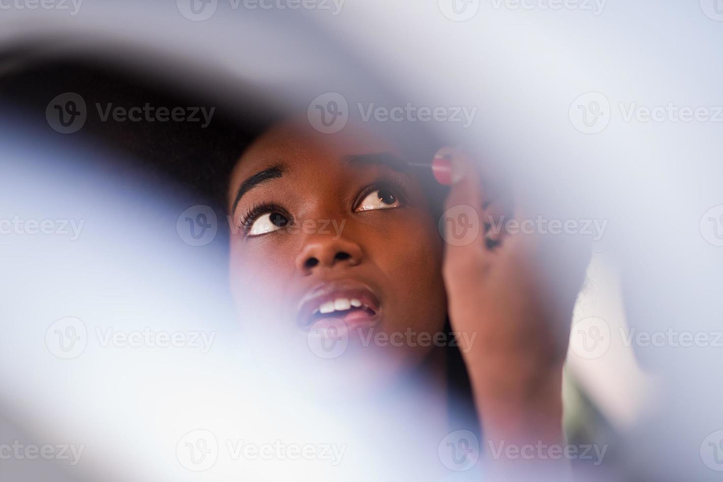 a young African-American woman makeup in the car photo