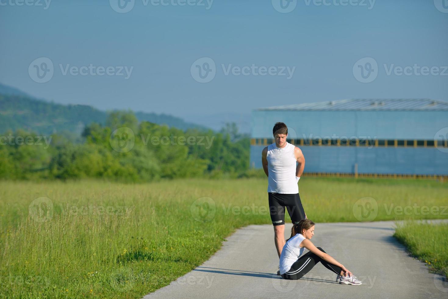 people doing stretching exercise  after jogging photo