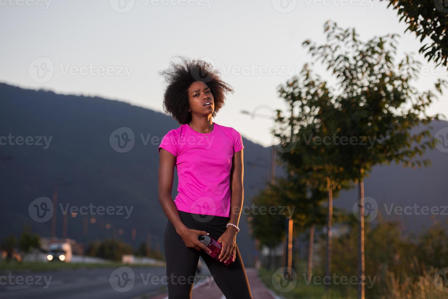 Portrait of a young african american woman running outdoors photo