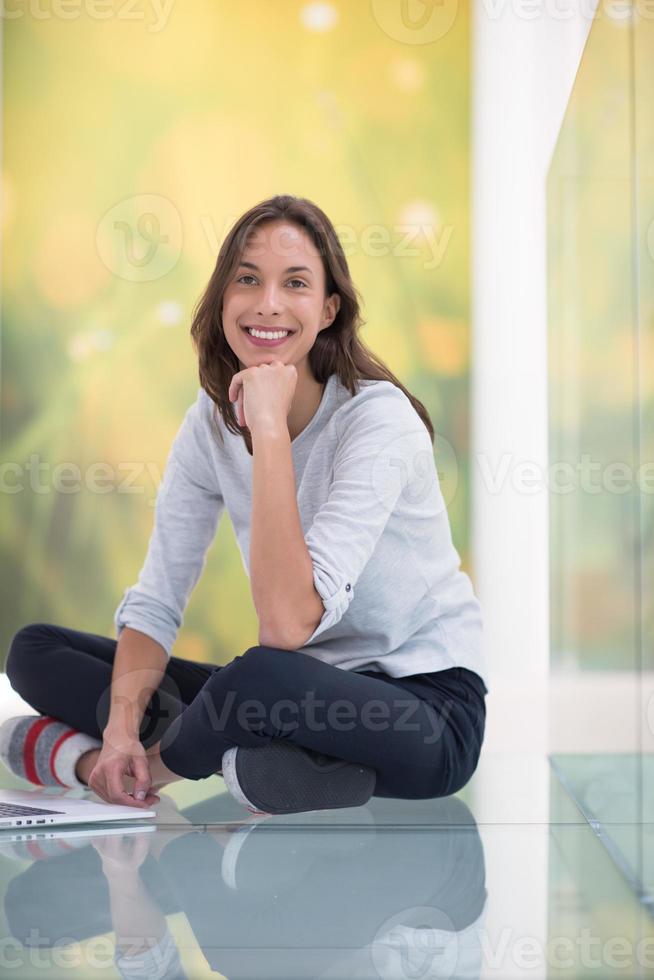 young women using laptop computer on the floor photo