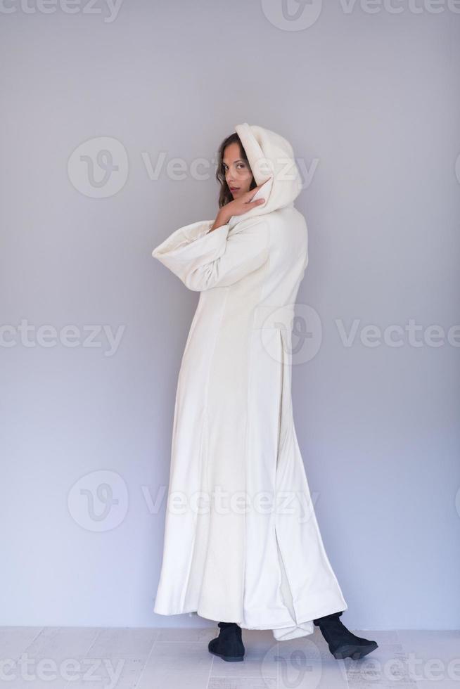 woman in a white coat with hood isolated on white background photo